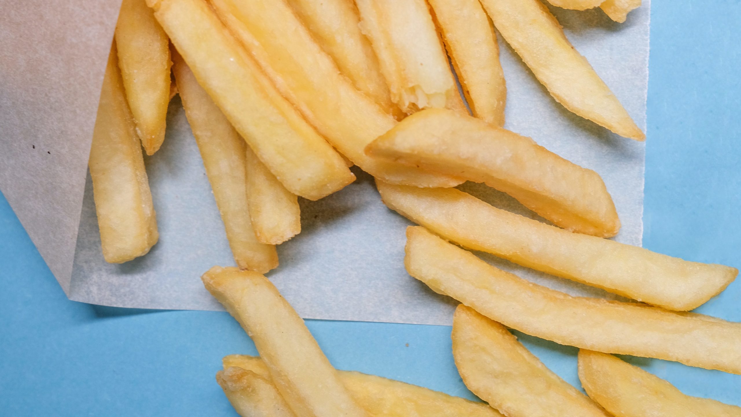 Generic stock photo of french fries on a blue background 